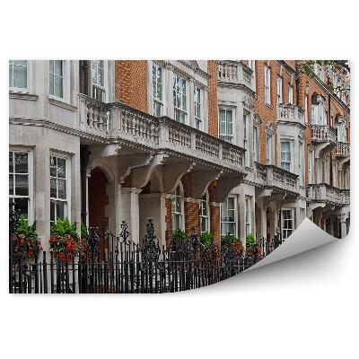 Papier peint Ruelle de maisons de rapport rangée de bâtiments clôturés