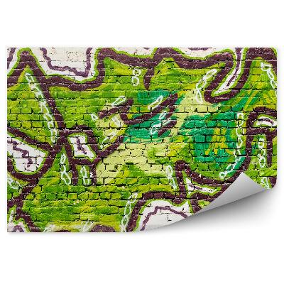 Papier peint Graffiti vert sur un mur de briques beige