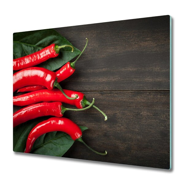 Protège plaque de cuisson Piments sur une planche