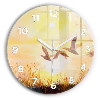 Horloge ronde en verre Grues au coucher du soleil