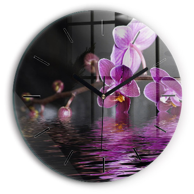 Fleur d'orchidée sur l'eau Pendule murale ronde