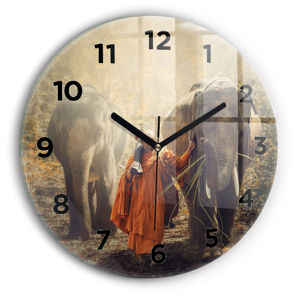 Horloge ronde Moine guidant des éléphants